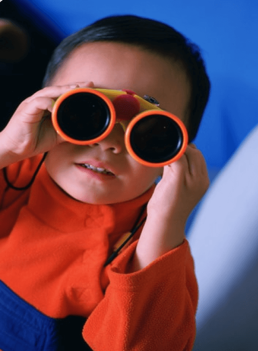 kid playing with binoculars